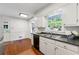 Bright kitchen with stainless steel sink, white cabinetry, hardwood floors, and natural light at 3300 Old Mill Ct, Decatur, GA 30033