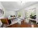 Sunlit living room with hardwood floors, contemporary decor, and seamless flow to dining at 3300 Old Mill Ct, Decatur, GA 30033