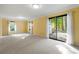 Spacious living room with neutral carpet, large windows, and outdoor access at 3300 Old Mill Ct, Decatur, GA 30033