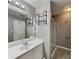 Bright bathroom with modern vanity, shower with glass door, and decorative shelving at 4603 Parkway Circle, Atlanta, GA 30349