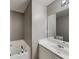 Bathroom featuring a bathtub with jets, a sink with white cabinets, and a mirror at 4603 Parkway Circle, Atlanta, GA 30349