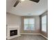 Bright living room featuring a classic fireplace, large windows, and modern gray floors at 4603 Parkway Circle, Atlanta, GA 30349