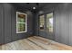 Cozy outdoor deck with double doors and a view of the wooded backyard at 6132 Hutchins Dr, Buford, GA 30518