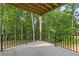 An outdoor deck with black metal railings overlooks lush greenery, offering a serene view at 6132 Hutchins Dr, Buford, GA 30518