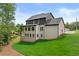 Exterior view of home with a modern design, white brick, dark accents, and a well-manicured lawn at 6132 Hutchins Dr, Buford, GA 30518