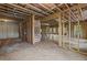 Unfinished basement with exposed framing, concrete floors, and natural light from several windows at 6132 Hutchins Dr, Buford, GA 30518