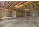 Unfinished basement with exposed insulation, concrete floors, and temporary lighting at 6132 Hutchins Dr, Buford, GA 30518