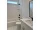 Modern bathroom featuring a white bathtub and vanity with dark fixtures, providing a sleek contrast at 6132 Hutchins Dr, Buford, GA 30518