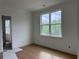 Bright bedroom with hardwood floors, white walls, and large windows at 6132 Hutchins Dr, Buford, GA 30518