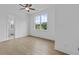 Bright, airy bedroom with hardwood floors, large windows, and ceiling fan at 6132 Hutchins Dr, Buford, GA 30518