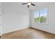 Bright, airy bedroom with hardwood floors, large window, and modern ceiling fan at 6132 Hutchins Dr, Buford, GA 30518