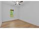 Empty bedroom with hardwood flooring, ceiling fan, and lots of natural light from a window at 6132 Hutchins Dr, Buford, GA 30518