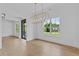 Bright dining room featuring hardwood floors, a modern light fixture, and large windows offering natural light at 6132 Hutchins Dr, Buford, GA 30518