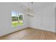 View of a modern and spacious dining room with elegant light fixture at 6132 Hutchins Dr, Buford, GA 30518