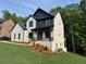 Beautiful two-story home featuring a stylish white brick exterior and a well-maintained lawn at 6132 Hutchins Dr, Buford, GA 30518