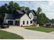 Charming two-story home featuring a brick facade, black accents, and well-manicured lawn at 6132 Hutchins Dr, Buford, GA 30518