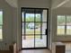 Elegant foyer featuring a black-framed glass front door and bright, neutral walls at 6132 Hutchins Dr, Buford, GA 30518