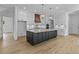 Bright kitchen with a large island, modern cabinetry, stainless steel appliances, and stylish lighting at 6132 Hutchins Dr, Buford, GA 30518