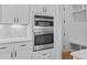 Modern kitchen with stainless steel appliances and a built-in double oven at 6132 Hutchins Dr, Buford, GA 30518