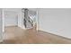 Open living area with hardwood floors, staircase, and modern light fixture at 6132 Hutchins Dr, Buford, GA 30518