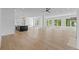 Expansive living area featuring hardwood floors, modern lighting, and abundant natural light at 6132 Hutchins Dr, Buford, GA 30518