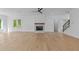 Open-concept living area featuring hardwood floors, fireplace, and double doors to the patio at 6132 Hutchins Dr, Buford, GA 30518
