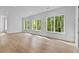 Bright, open living room featuring hardwood floors and large windows offering scenic views at 6132 Hutchins Dr, Buford, GA 30518