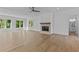 Spacious living room with hardwood floors, fireplace and a view to the bathroom at 6132 Hutchins Dr, Buford, GA 30518