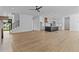 Expansive living area featuring hardwood floors, kitchen, staircase and modern light fixtures at 6132 Hutchins Dr, Buford, GA 30518