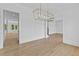 Spacious living room with light wood flooring and decorative white trim at 6132 Hutchins Dr, Buford, GA 30518