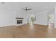 Cozy living room featuring hardwood floors, fireplace, staircase and modern light fixtures at 6132 Hutchins Dr, Buford, GA 30518