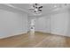 Spacious primary bedroom features hardwood floors, bright windows, a ceiling fan, and ensuite bathroom at 6132 Hutchins Dr, Buford, GA 30518