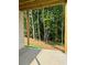 Covered outdoor patio with views of wooded backyard at 6132 Hutchins Dr, Buford, GA 30518