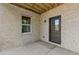 Covered outdoor patio with a window and door, providing a versatile living area at 6132 Hutchins Dr, Buford, GA 30518
