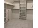 Spacious walk-in closet with custom shelving and marble floors at 6132 Hutchins Dr, Buford, GA 30518