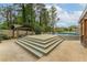 Spacious backyard showcasing a pool, wooden deck, and patio, offering ample space for recreation and leisure at 1337 Frontier Trl, Sugar Hill, GA 30518