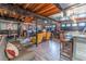 Spacious finished basement with bar, living room, desk, and exposed ceiling at 1337 Frontier Trl, Sugar Hill, GA 30518