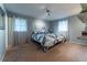 Cozy bedroom featuring a modern quilt, natural light, and light blue walls at 1337 Frontier Trl, Sugar Hill, GA 30518