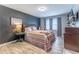 Bedroom featuring a decorative dark grey accent wall and neutral floors at 1337 Frontier Trl, Sugar Hill, GA 30518