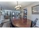 Dining room with views into the kitchen and living room, featuring a large table and chandelier at 1337 Frontier Trl, Sugar Hill, GA 30518