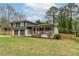 View of the front exterior showing the front yard and covered porch with white pillars at 1337 Frontier Trl, Sugar Hill, GA 30518
