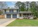 Charming split-level home with a two-car garage, covered porch, and well-maintained lawn at 1337 Frontier Trl, Sugar Hill, GA 30518