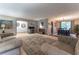 Open-concept living room with views of the dining area, and office space at 1337 Frontier Trl, Sugar Hill, GA 30518
