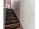 Interior stairway of the home with brown stairs and gray walls at 1337 Frontier Trl, Sugar Hill, GA 30518