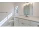 Bathroom featuring a white vanity, quartz countertop and a framed mirror at 2867 Payton Ne Rd, Atlanta, GA 30345