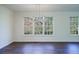 Dining room showcasing a modern chandelier and large windows overlooking the yard at 2867 Payton Ne Rd, Atlanta, GA 30345