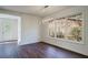 Well-lit dining room featuring modern lighting, hardwood floors, white walls, and bright windows at 2867 Payton Ne Rd, Atlanta, GA 30345