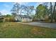 Charming home exterior with a spacious driveway, a lush lawn, and a wooden back deck at 2867 Payton Ne Rd, Atlanta, GA 30345