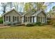Charming single-story home with blue front door, ramp access, gray siding, and dark shutters, surrounded by lush landscaping at 2867 Payton Ne Rd, Atlanta, GA 30345