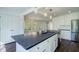 Open kitchen featuring a large dark countertop island, stainless steel appliances and white cabinetry at 2867 Payton Ne Rd, Atlanta, GA 30345